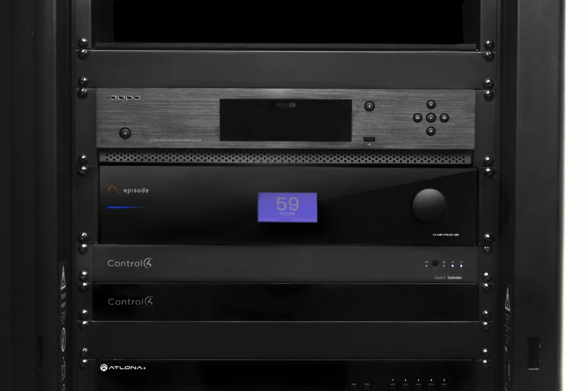 A neat equipment rack with an Episode amplifier, Control4 controllers and a media player