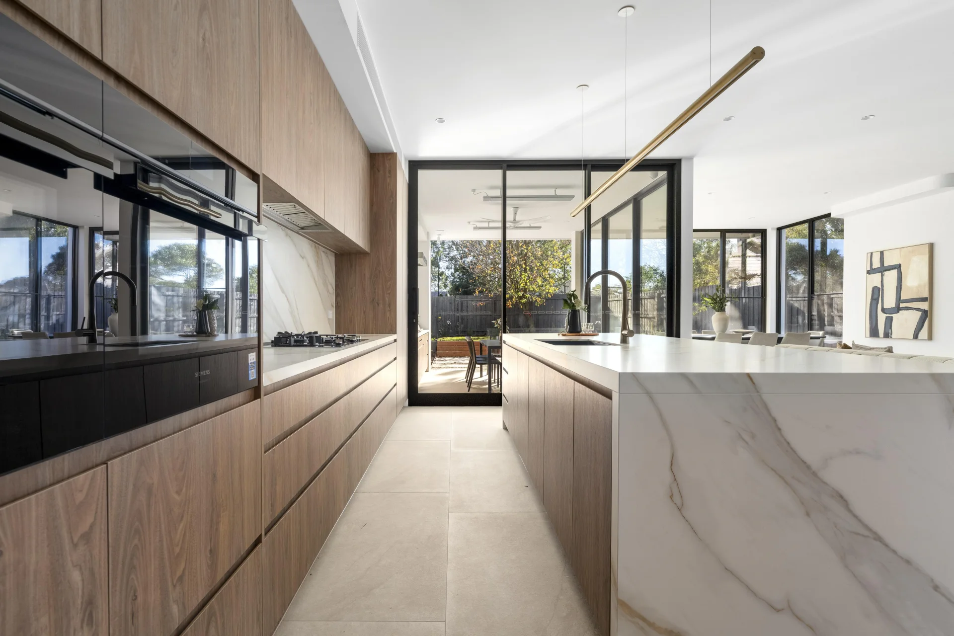 Layered kitchen and garden lighting in NorthTech's Mont Albert smart-home project
